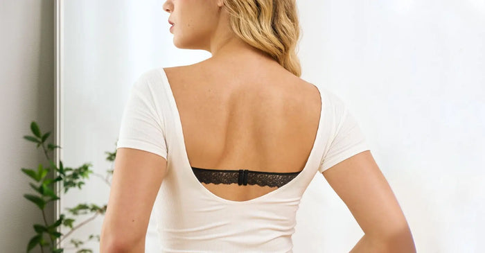 Femme appliquant un soin du visage et portant un soutien-gorge à bretelles visibles.