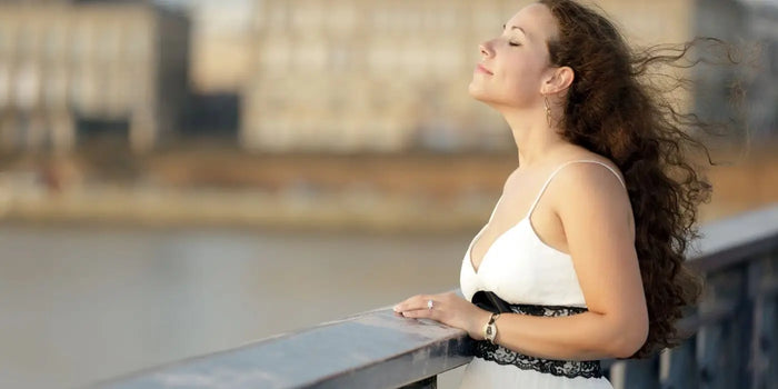 Femme portant une robe blanche sur un pont.