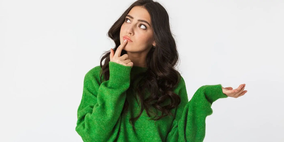Femme portant une robe pull verte.