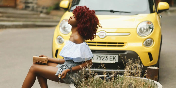 Femme portant une blouse blanche sans bretelles et un short à carreaux.