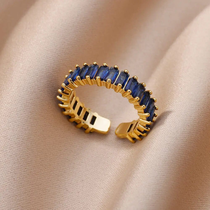 bague ajustable en or ornée de zircons bleus élégamment présentée sur un tissu beige, modèle yveline