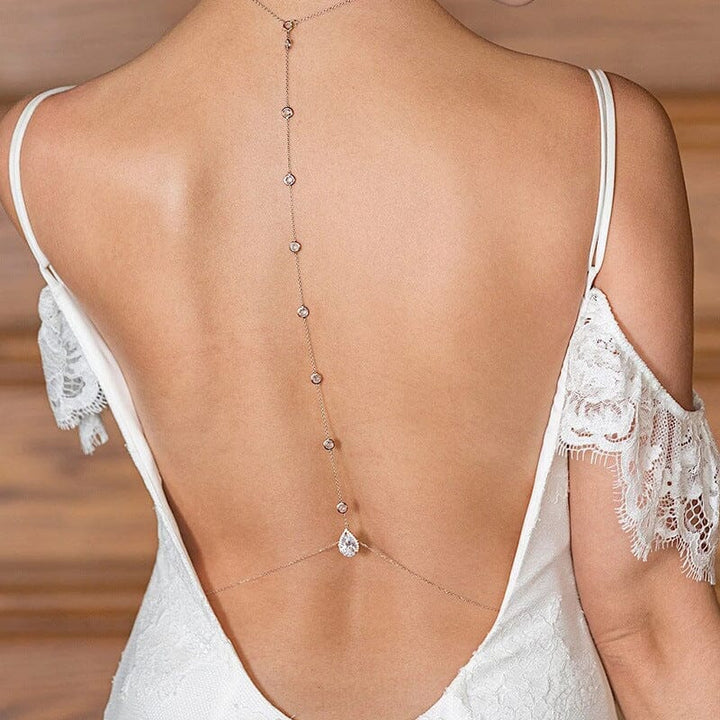 collier de dos mariée justine détaillé et délicat mettant en valeur une robe blanche avec des éléments en dentelle