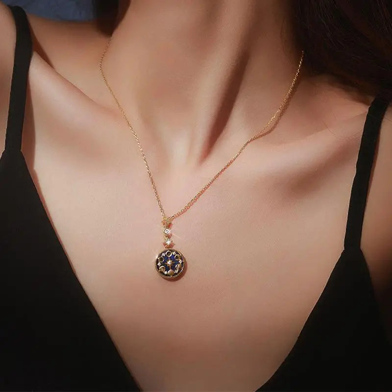 collier médaillon or cycle lunaire et ciel étoilé porté par une femme, bijou élégant pour une touche raffinée et chic