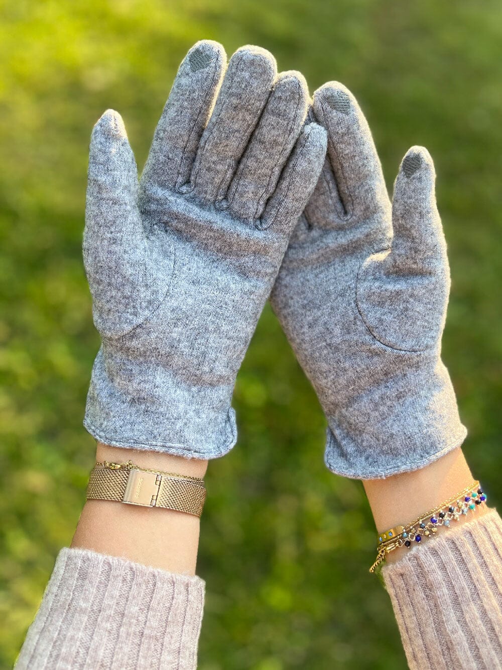 gants tactiles polaire femme léna en laine gris clair avec intérieur douillet, portés par une femme en pull blanc côtelé