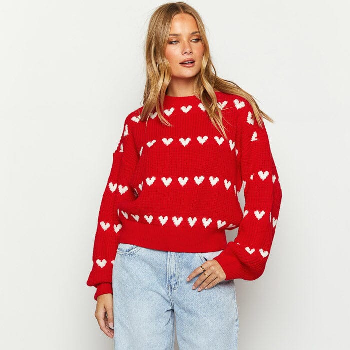 Pull rouge orné de motifs cœurs blancs, style décontracté et chic pour femme, idéal pour l'hiver et les sorties.