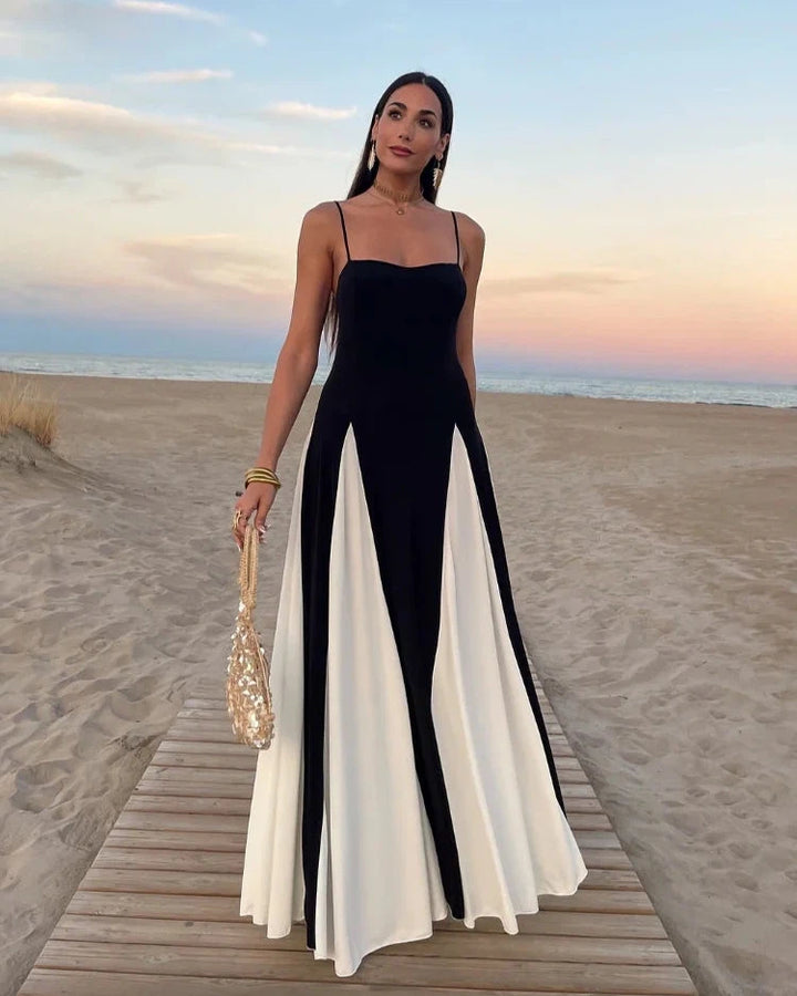 robe de bal noire édition limitée léonora élégante avec détails blancs portée sur la plage au coucher du soleil