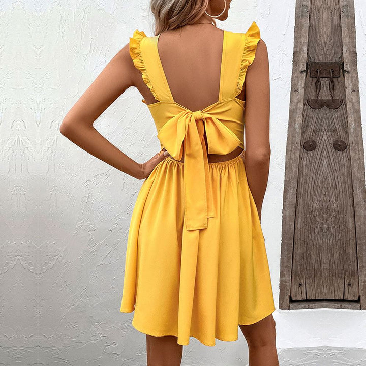 robe jaune avec un nœud dans le dos pour femme - modèle coralina, vue de dos montrant les détails du nœud et des volants