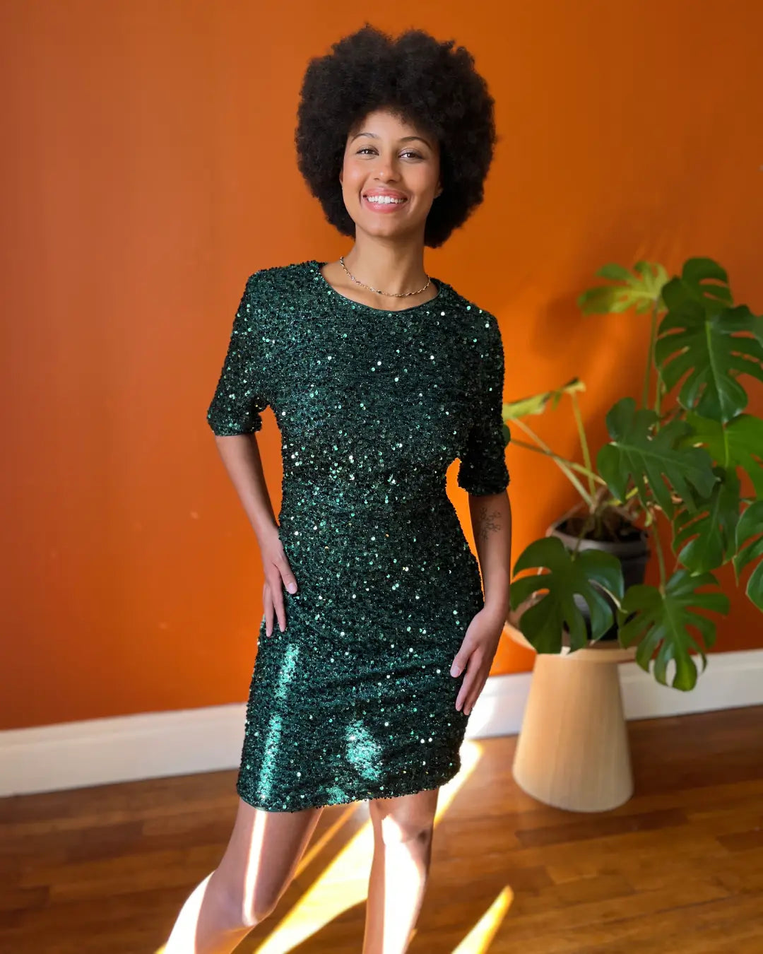 Robe de cocktail courte Cléophée en sequins verts élégants mettant en valeur une ambiance chic et moderne en intérieur.