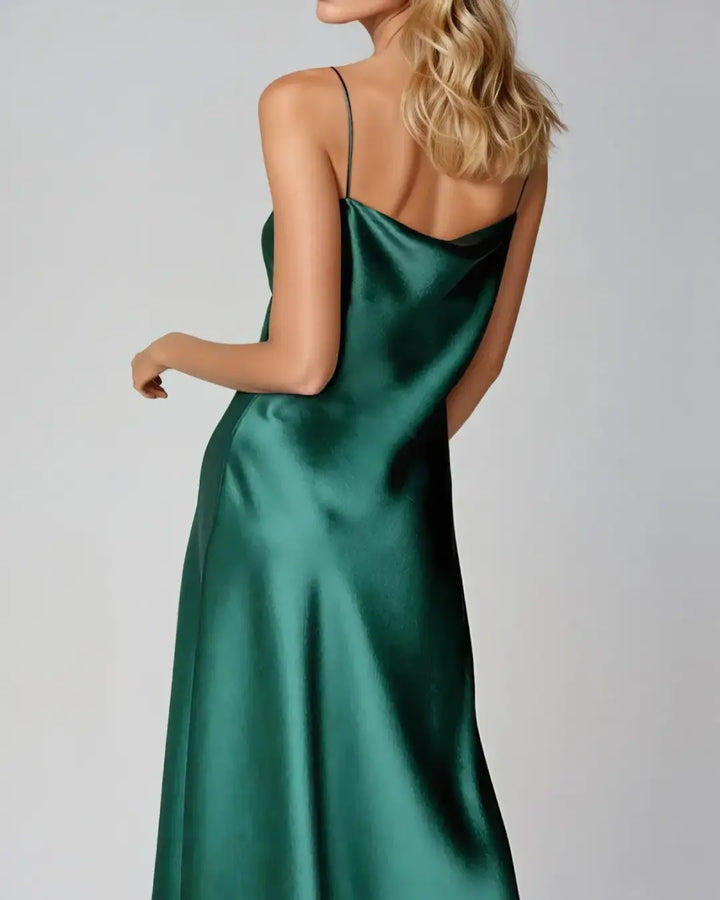 Robe cocktail en satin verte avec bretelles fines, élégante et moderne pour des soirées raffinées et occasions spéciales.