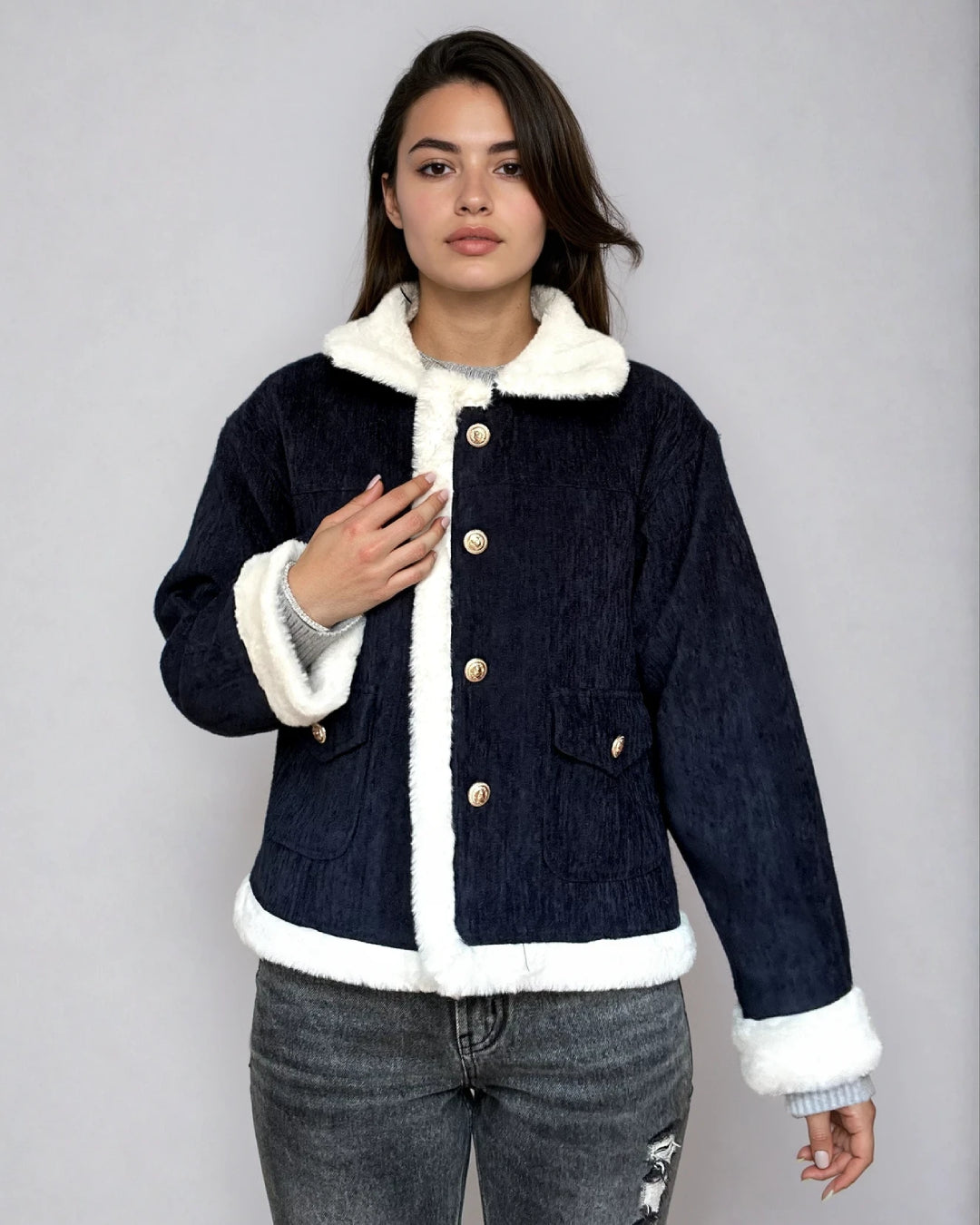 Veste en velours bleu marine avec fausse fourrure blanche, boutons dorés, style élégant pour look d'hiver tendance.