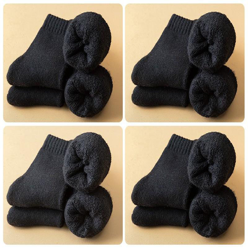 Lot de chaussettes chaudes en laine mérino pour l'hiver, quatre paires noires, idéal pour garder les pieds au chaud.