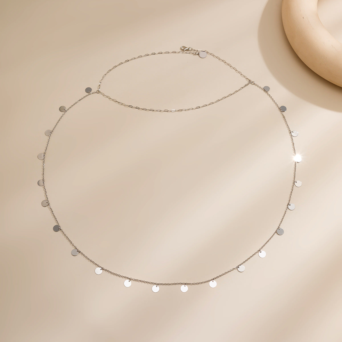 Collier pour le dos Alya, délicat bijou minimaliste avec breloques en argent, parfait pour un look élégant et original.