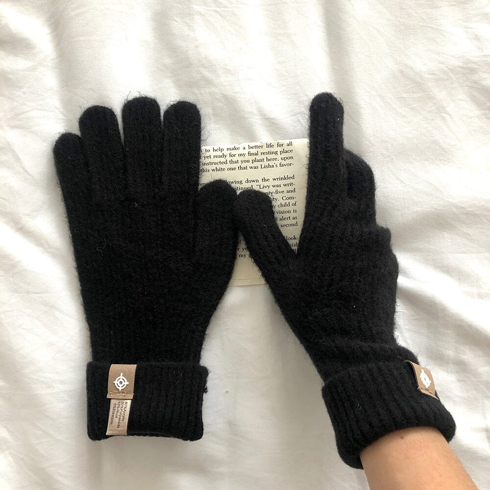 gants noirs en laine longs compatibles avec écrans tactiles, posés sur un livre blanc, idéale pour l'hiver et le confort