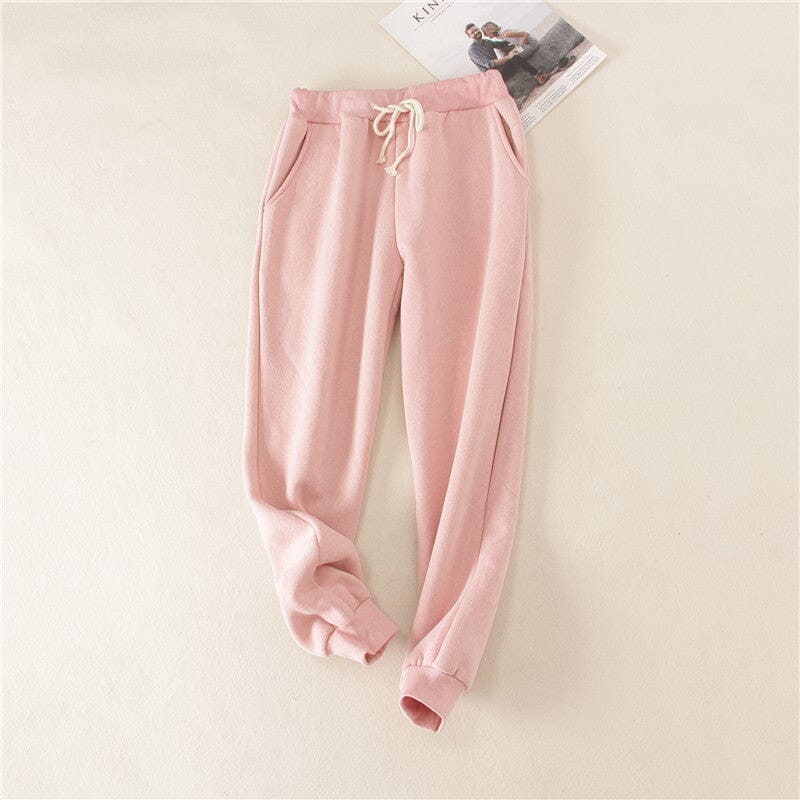 Pantalon de jogging polaire femme rose idéal pour l'hiver avec poches et cordon de serrage, style confortable et chaud.