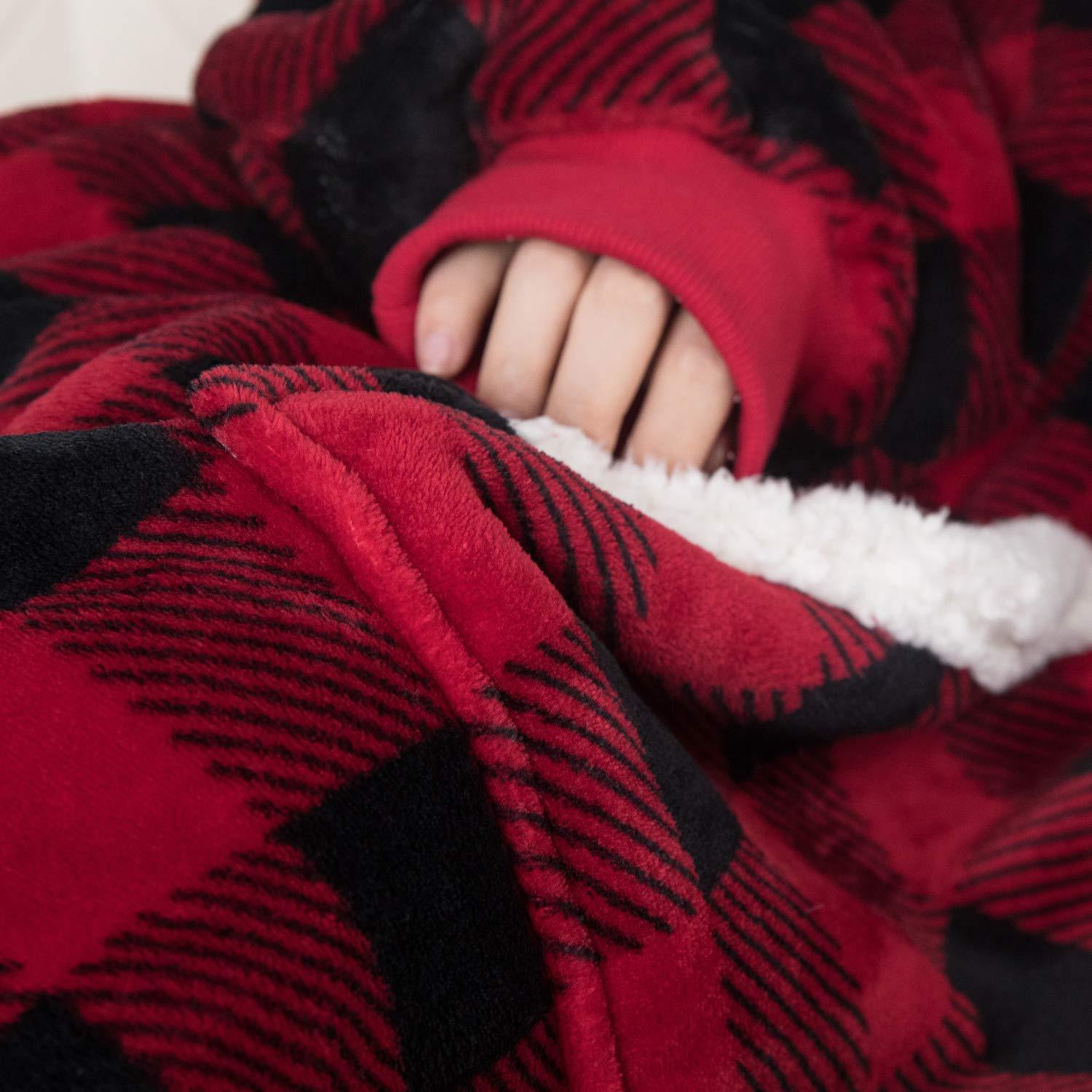 gros plan d’un pull plaid couverture rouge et noir à l'intérieur en sherpa blanc, porté par une personne allongée